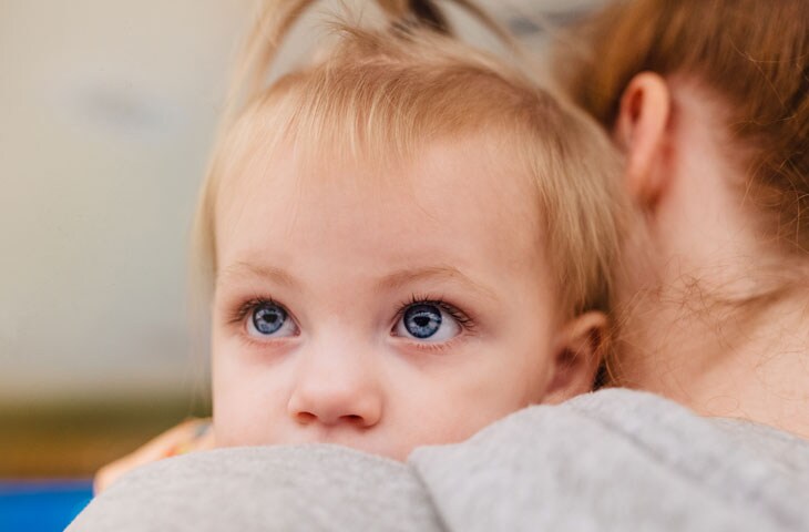 mother holding daughter in pediatric hospital